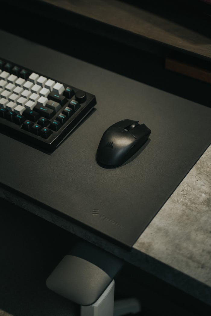 A sleek gaming setup featuring a mechanical keyboard and wireless mouse on a stylish desk.
